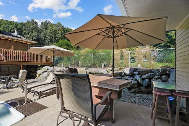 view of patio with fence and outdoor dining space