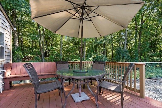wooden deck featuring outdoor dining area