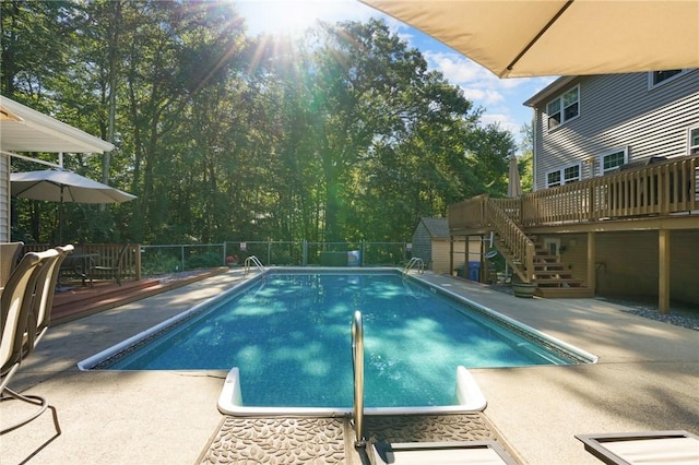 view of pool with a fenced in pool, stairway, a patio area, and a deck
