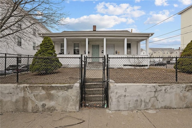 752 Social St, Woonsocket, RI 02895 - view of front of property featuring a gate, a fenced front yard, a chimney, and a porch