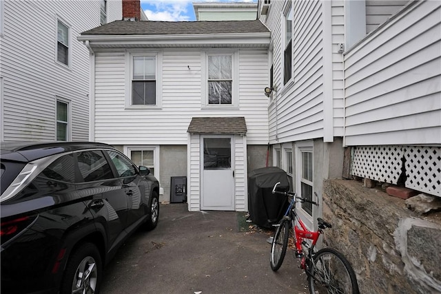 752 Social St, Woonsocket, RI 02895 - view of side of home with a shingled roof and a chimney
