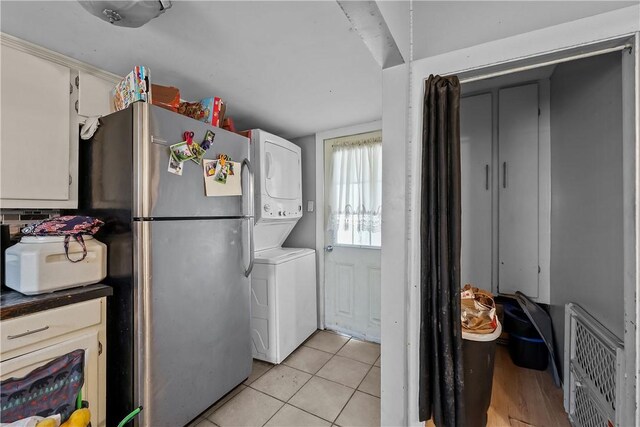 752 Social St, Woonsocket, RI 02895 - clothes washing area with laundry area, light tile patterned floors, and stacked washer / drying machine