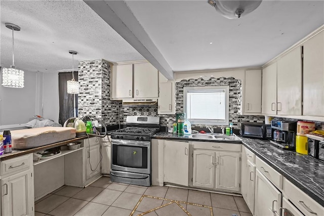 752 Social St, Woonsocket, RI 02895 - kitchen featuring stainless steel range with gas stovetop, a sink, light tile patterned floors, and dark countertops