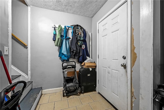 752 Social St, Woonsocket, RI 02895 - interior space featuring tile patterned flooring, a textured ceiling, and stairway