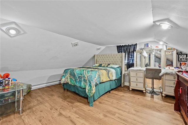 752 Social St, Woonsocket, RI 02895 - bedroom featuring a baseboard heating unit, wood finished floors, and lofted ceiling