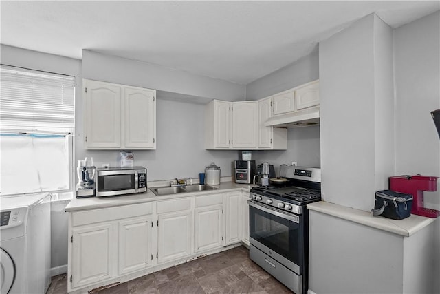 752 Social St, Woonsocket, RI 02895 - kitchen featuring white cabinets, light countertops, washer / clothes dryer, stainless steel appliances, and under cabinet range hood