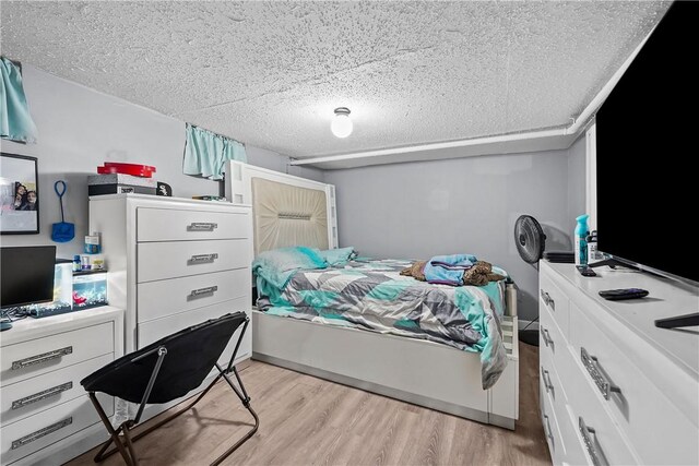 752 Social St, Woonsocket, RI 02895 - bedroom featuring light wood-type flooring and a textured ceiling