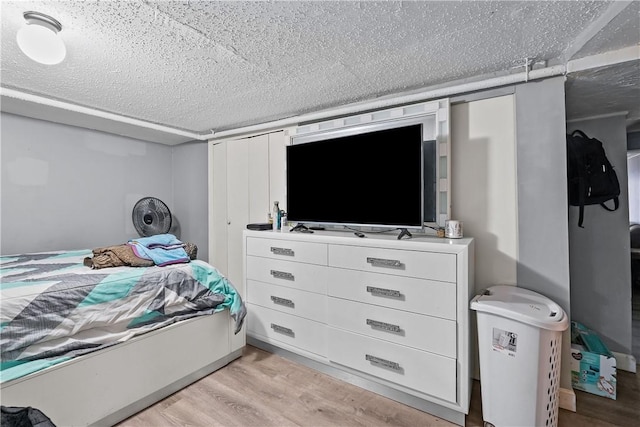 752 Social St, Woonsocket, RI 02895 - bedroom with light wood-style floors and a textured ceiling