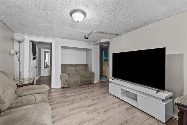 752 Social St, Woonsocket, RI 02895 - living area with baseboards, a textured ceiling, and light wood-style flooring