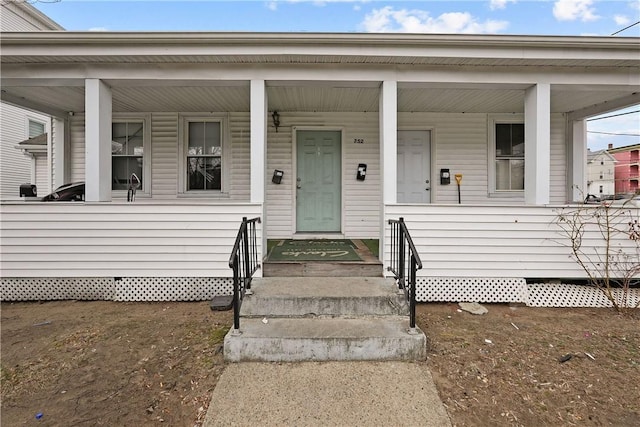 752 Social St, Woonsocket, RI 02895 - doorway to property featuring covered porch