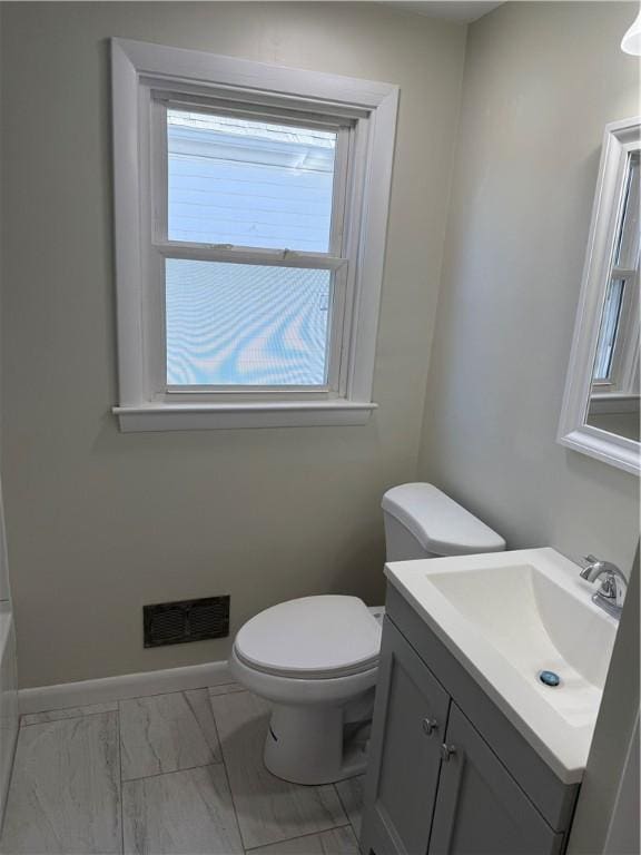 26 Yale Ave, East Providence, RI 02915 - bathroom featuring visible vents, vanity, marble finish floor, a washtub, and toilet