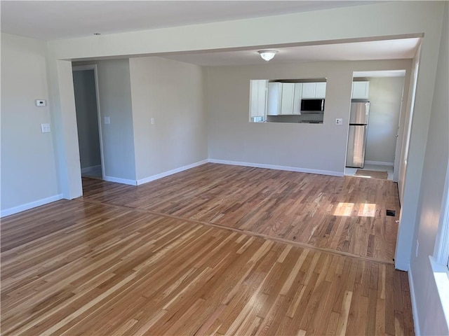 26 Yale Ave, East Providence, RI 02915 - unfurnished living room featuring light wood-style floors and baseboards