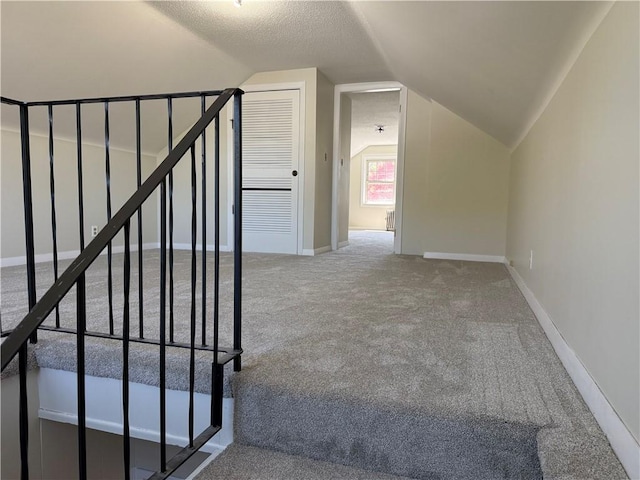 bonus room featuring baseboards, carpet, and vaulted ceiling