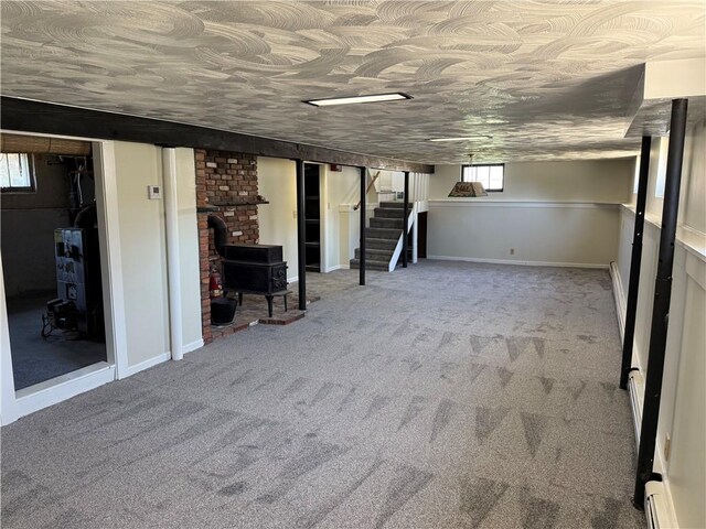 29 Lindy Ave, East Providence, RI 02915 - basement with stairway, carpet, and a wood stove