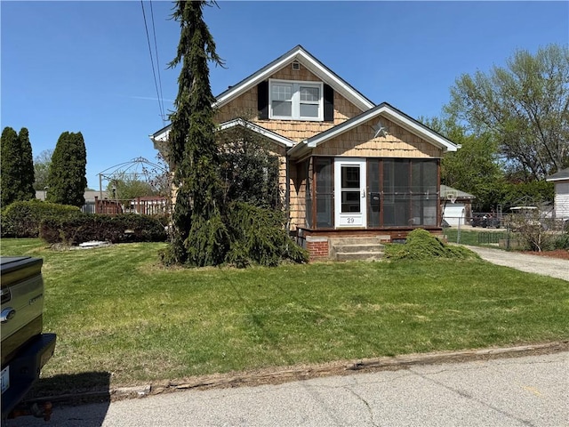 29 Lindy Ave, East Providence, RI 02915 - bungalow-style home with fence, a sunroom, and a front lawn