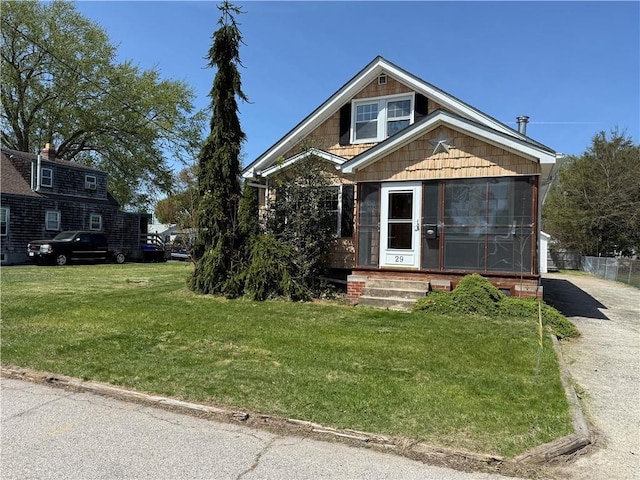 29 Lindy Ave, East Providence, RI 02915 - view of front of property featuring a sunroom and a front lawn