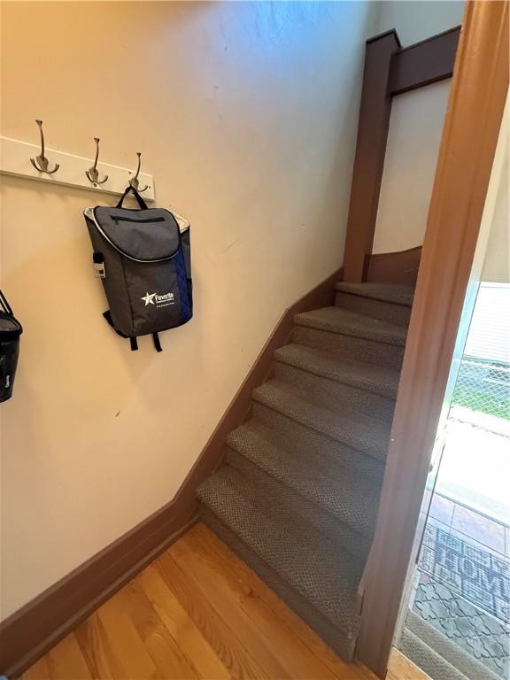 stairs with baseboards and wood finished floors