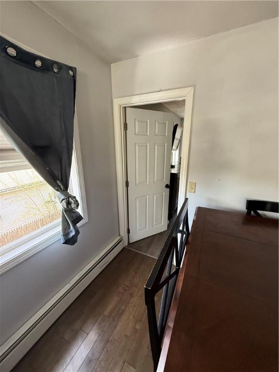 entryway featuring a baseboard heating unit and dark wood-style floors