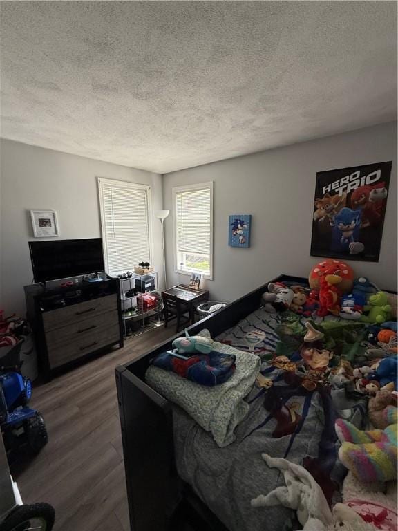 bedroom featuring a textured ceiling and wood finished floors
