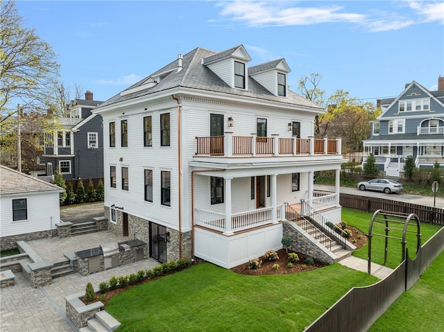 7 Champlin St, Newport, RI 02840 - rear view of property with a porch, fence, a balcony, a yard, and an outdoor kitchen