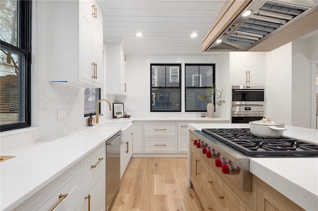 7 Champlin St, Newport, RI 02840 - kitchen with exhaust hood, a sink, light wood-style floors, stainless steel appliances, and recessed lighting