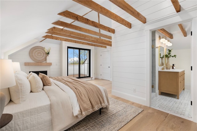 7 Champlin St, Newport, RI 02840 - bedroom with wood walls, vaulted ceiling with beams, a fireplace, and light wood-type flooring