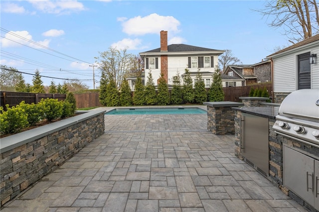 7 Champlin St, Newport, RI 02840 - view of patio / terrace with a fenced in pool, a fenced backyard, a grill, and an outdoor kitchen
