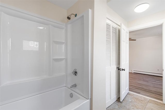 full bath featuring baseboard heating and shower / tub combination