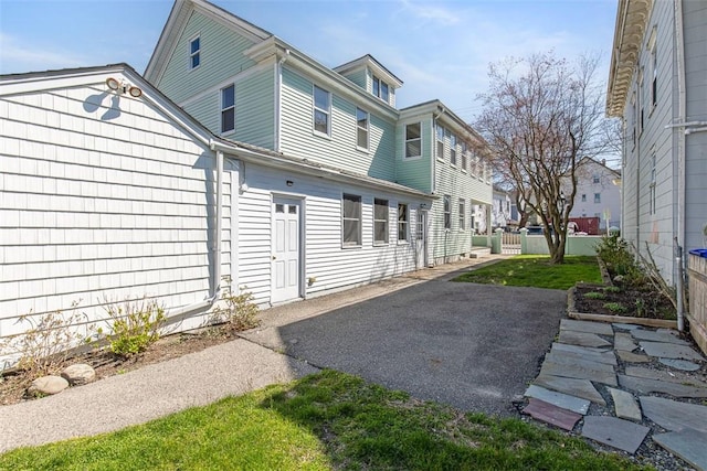 view of side of home featuring fence and a patio area
