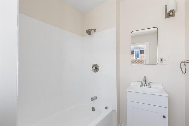bathroom featuring vanity and shower / tub combination