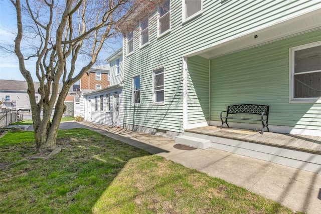 view of exterior entry featuring a lawn