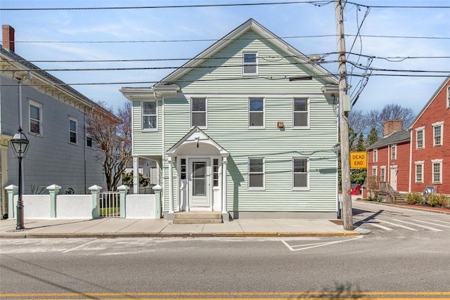 view of front facade featuring fence
