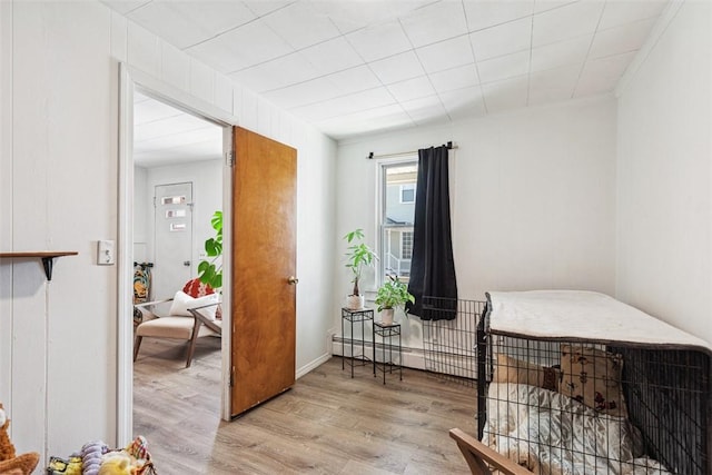 67 Pleasant St, Westerly, RI 02891 - bedroom featuring a baseboard radiator and wood finished floors