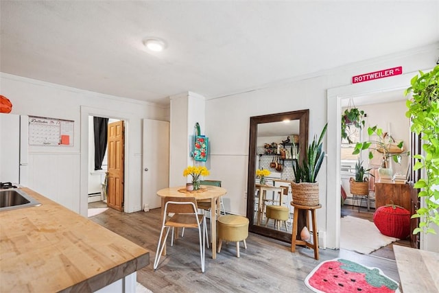 67 Pleasant St, Westerly, RI 02891 - dining area with ornamental molding, baseboard heating, and light wood-type flooring