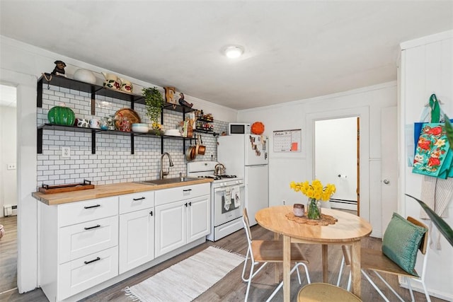 67 Pleasant St, Westerly, RI 02891 - kitchen featuring wood finished floors, white appliances, butcher block countertops, a baseboard heating unit, and a sink