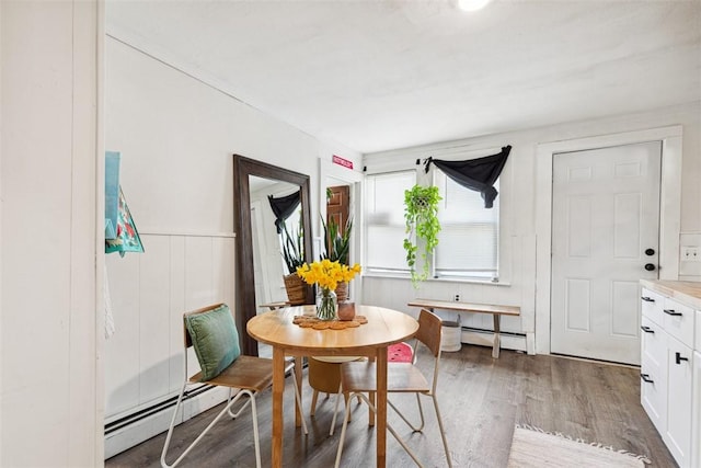67 Pleasant St, Westerly, RI 02891 - dining area with a wainscoted wall, a baseboard heating unit, and wood finished floors