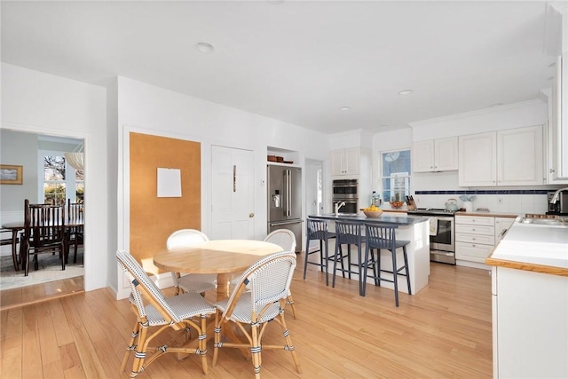 dining room featuring light wood-style floors and recessed lighting