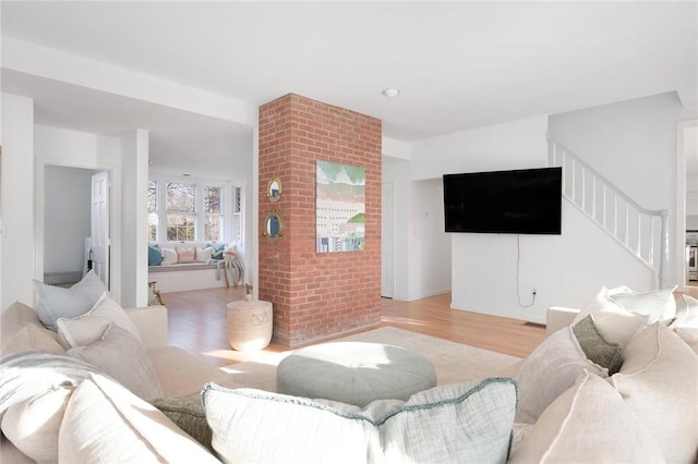 living room featuring stairs and wood finished floors