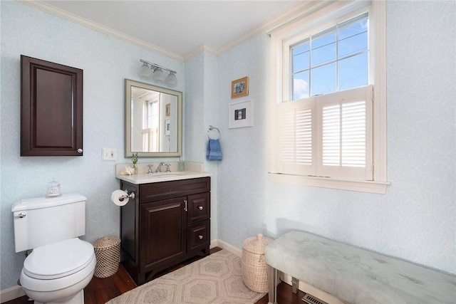 bathroom with vanity, ornamental molding, and toilet