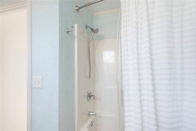 bathroom featuring ornamental molding and shower / tub combo with curtain