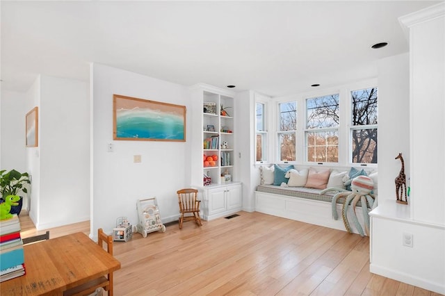living area with light wood-type flooring and visible vents