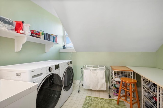 washroom with laundry area, washing machine and dryer, and baseboards
