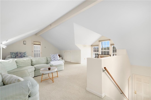 living room with baseboards, vaulted ceiling with beams, and light colored carpet