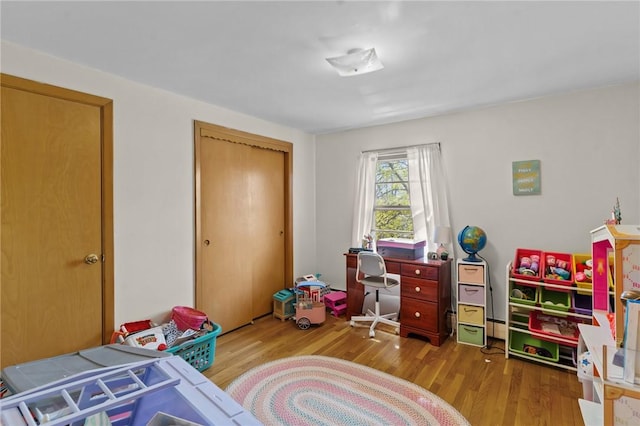 bedroom featuring wood finished floors and a closet
