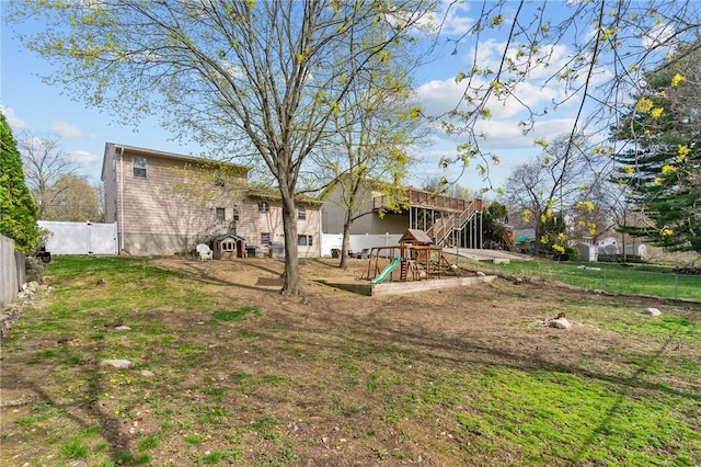 view of yard with a playground and a fenced backyard
