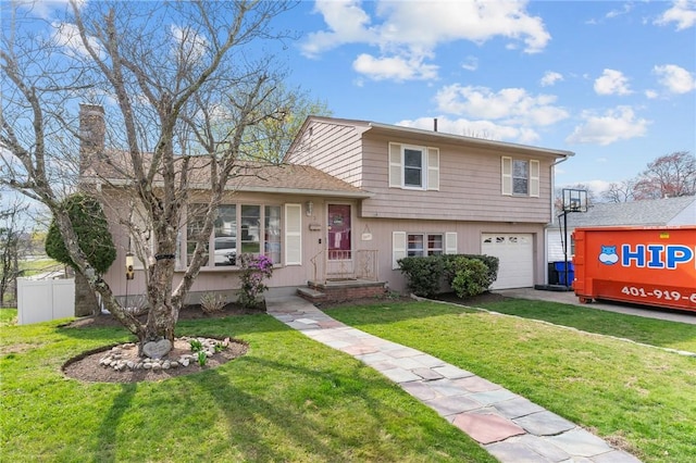 split level home featuring driveway, a chimney, a front yard, a garage, and fence