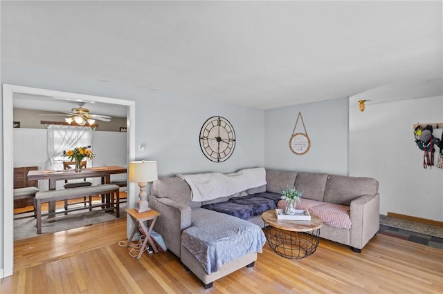 living room with a ceiling fan and hardwood / wood-style flooring