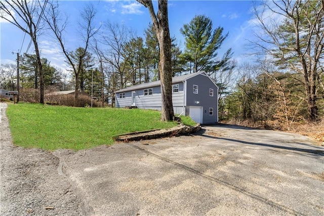 view of outbuilding with a garage and driveway
