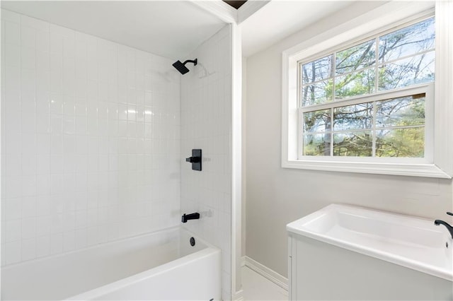 bathroom featuring baseboards and  shower combination
