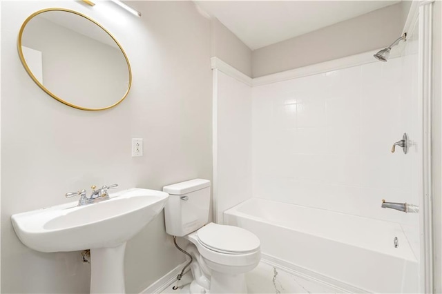 bathroom with shower / bath combination, marble finish floor, baseboards, and toilet